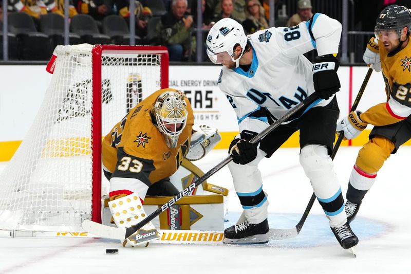 Sep 27, 2024; Las Vegas, Nevada, USA; Utah Hockey Club forward Kevin Stenlund (82) shoots against Vegas Golden Knights goaltender Adin Hill (33) during the third period at T-Mobile Arena. Mandatory Credit: Stephen R. Sylvanie-Imagn Images