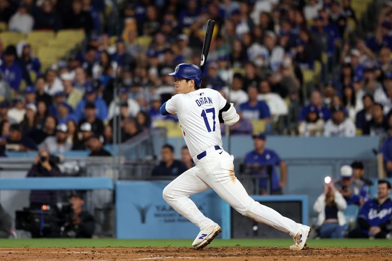 Jun 1, 2024; Los Angeles, California, USA;  Los Angeles Dodgers designated hitter Shohei Ohtani (17) hits a single during the seventh inning against the Colorado Rockies at Dodger Stadium. Mandatory Credit: Kiyoshi Mio-USA TODAY Sports