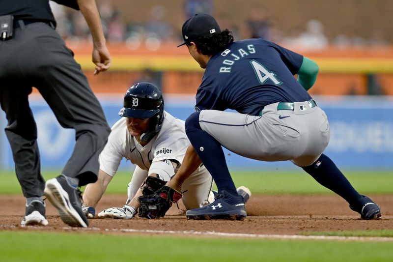 Aug 13, 2024; Detroit, Michigan, USA;  Detroit Tigers catcher Jake Rogers (34) is tagged out at third base trying to stretch a double into a triple by Seattle Mariners third baseman Josh Rojas (4) in the sixth inning at Comerica Park. Mandatory Credit: Lon Horwedel-USA TODAY Sports