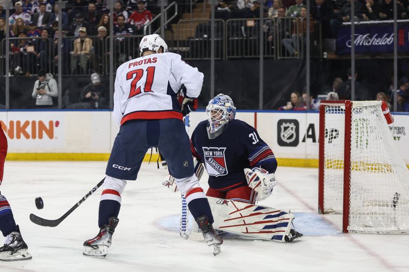 Mar 5, 2025; New York, New York, USA;  New York Rangers goaltender Igor Shesterkin (31) defends the net from a shot on goal attempt from Washington Capitals center Aliaksei Protas (21) in the first period at Madison Square Garden. Mandatory Credit: Wendell Cruz-Imagn Images