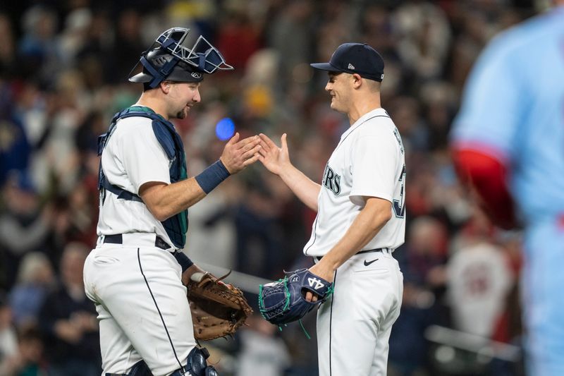 Apr 22, 2023; Seattle, Washington, USA; Seattle Mariners catcher Cal Raleigh (29), left, and relief pitcher Paul Sewald (37) celebrate after a game against the St. Louis Cardinals at T-Mobile Park. Mandatory Credit: Stephen Brashear-USA TODAY Sports