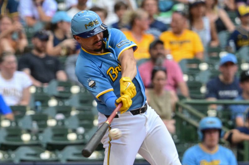 Jul 14, 2024; Milwaukee, Wisconsin, USA;  Milwaukee Brewers shortstop Willy Adames (27) hits a single to drive in a run in the fourth inning against the Washington Nationals at American Family Field. Mandatory Credit: Benny Sieu-USA TODAY Sports