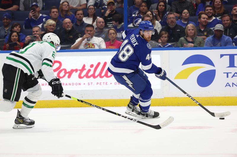 Dec 4, 2023; Tampa, Florida, USA; Tampa Bay Lightning defenseman Nick Perbix (48) skates with the puck as Dallas Stars left wing Jason Robertson (21) defends during the first period at Amalie Arena. Mandatory Credit: Kim Klement Neitzel-USA TODAY Sports