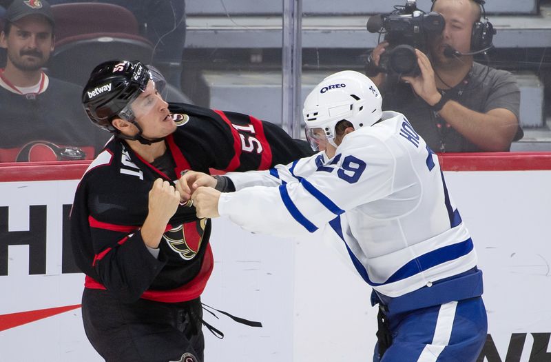 Sep 24, 2024; Ottawa, Ontario, CAN; Ottawa Senators left wing Cole Reinhardt (51) fights with Toronto Maple Leafs right wing Pontus Holmberg (29) in the third period at the Canadian Tire Centre. Mandatory Credit: Marc DesRosiers-Imagn Images