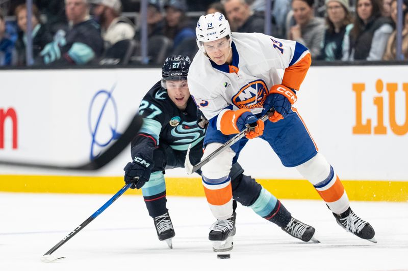 Jan 21, 2026; Seattle, Washington, USA; New York Islanders forward Mathew Barzal (13) skates against Seattle Kraken forward Berkly Catton (27) during the first period at Climate Pledge Arena. Mandatory Credit: Stephen Brashear-Imagn Images