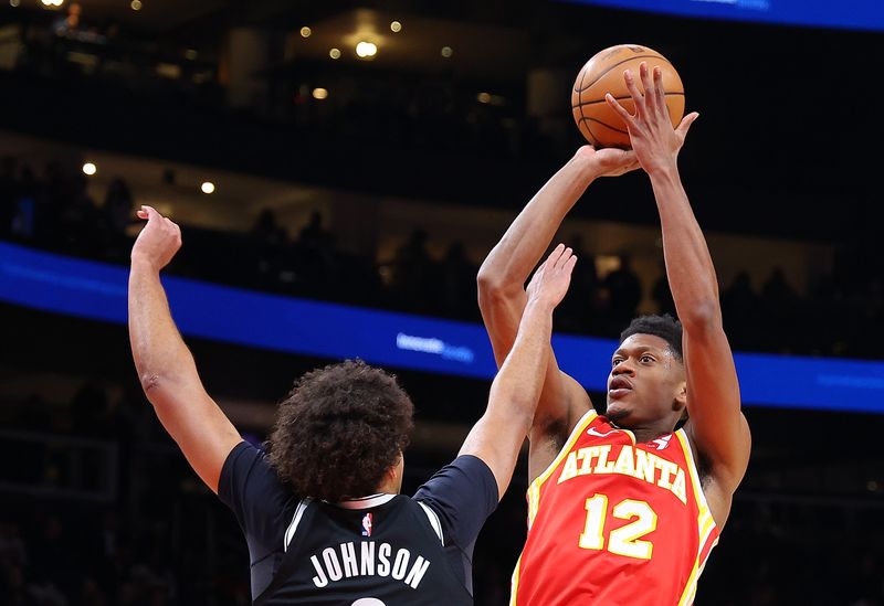 ATLANTA, GEORGIA - DECEMBER 06:  De'Andre Hunter #12 of the Atlanta Hawks attempts a shot against Cameron Johnson #2 of the Brooklyn Nets during the first quarter at State Farm Arena on December 06, 2023 in Atlanta, Georgia.  NOTE TO USER: User expressly acknowledges and agrees that, by downloading and/or using this photograph, user is consenting to the terms and conditions of the Getty Images License Agreement.  (Photo by Kevin C. Cox/Getty Images)