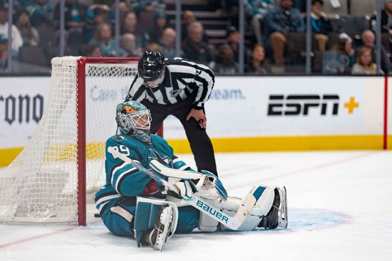 Nov 14, 2023; San Jose, California, USA; San Jose Sharks goaltender Mackenzie Blackwood (29) sits on the ice as the referee removes the puck from inside of the goal during the third period against the Florida Panthers at SAP Center at San Jose. Mandatory Credit: Stan Szeto-USA TODAY Sports