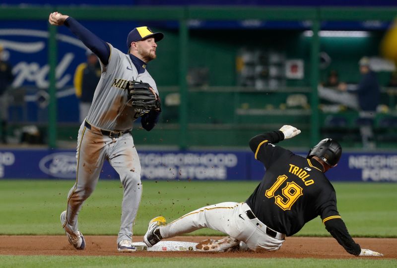 Apr 24, 2024; Pittsburgh, Pennsylvania, USA;  Milwaukee Brewers second baseman Brice Turang (2) turns a double play over Pittsburgh Pirates second baseman Jared Triolo (19) during the sixth inning at PNC Park. Mandatory Credit: Charles LeClaire-USA TODAY Sports