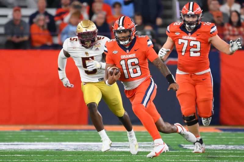 Nov 3, 2023; Syracuse, New York, USA; Syracuse Orange quarterback Carlos Del Rio-Wilson (16) runs as Boston College Eagles linebacker Kam Arnold (5) chases during the second half at the JMA Wireless Dome. Mandatory Credit: Rich Barnes-USA TODAY Sports