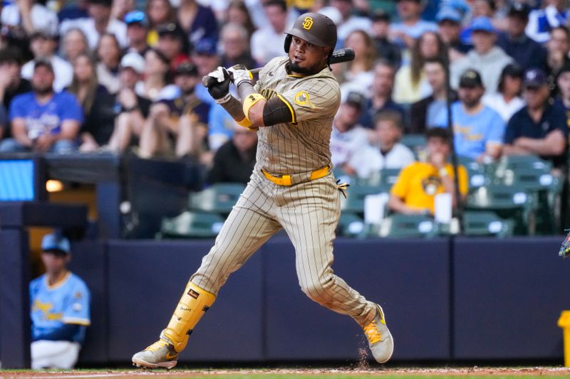 Jun 6, 2025; Milwaukee, Wisconsin, USA;  San Diego Padres designated hitter Luis Arraez (4) hits an RBI single during the third inning against the Milwaukee Brewers at American Family Field. Mandatory Credit: Jeff Hanisch-Imagn Images