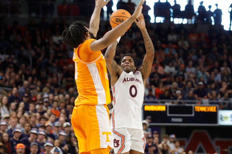 Mar 4, 2023; Auburn, Alabama, USA;  Auburn Tigers guard K.D. Johnson (0) shoots the ball against Tennessee Volunteers forward Jonas Aidoo (0) during the second half at Neville Arena. Mandatory Credit: John Reed-USA TODAY Sports