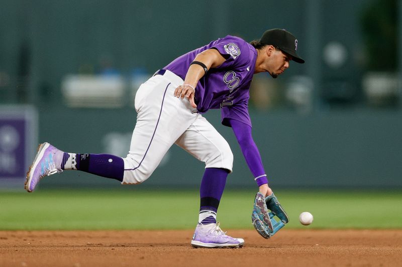 Aug 18, 2023; Denver, Colorado, USA; Colorado Rockies shortstop Ezequiel Tovar (14) fields the ball in the eighth inning against the Chicago White Sox at Coors Field. Mandatory Credit: Isaiah J. Downing-USA TODAY Sports
