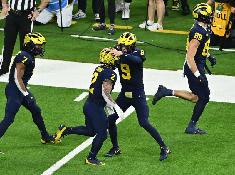 Jan 8, 2024; Houston, TX, USA; Michigan Wolverines running back Blake Corum (2) is congratulated by Michigan Wolverines quarterback J.J. McCarthy (9) after his touchdown run against the Washington Huskies in the fourth quarter in the 2024 College Football Playoff national championship game at NRG Stadium. Mandatory Credit: Maria Lysaker-USA TODAY Sports