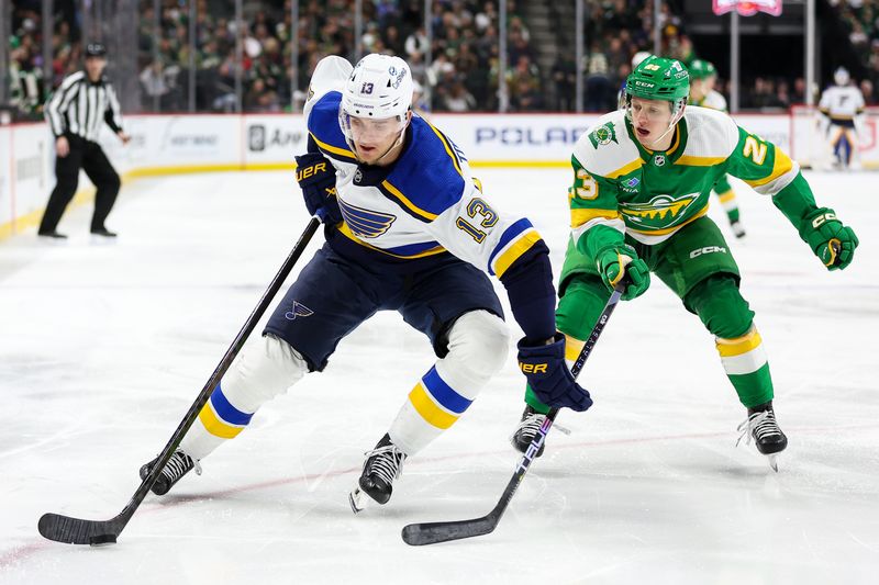 Mar 23, 2024; Saint Paul, Minnesota, USA; St. Louis Blues right wing Alexey Toropchenko (13) skates with the puck as Minnesota Wild center Marco Rossi (23) defends during the second period at Xcel Energy Center. Mandatory Credit: Matt Krohn-USA TODAY Sports