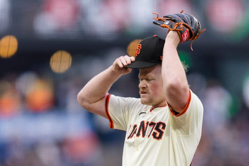 May 15, 2024; San Francisco, California, USA; San Francisco Giants starting pitcher Logan Webb (62) reacts after walking Los Angeles Dodgers catcher Will Smith (16) to load the bases during the first inning at Oracle Park. Mandatory Credit: John Hefti-USA TODAY Sports