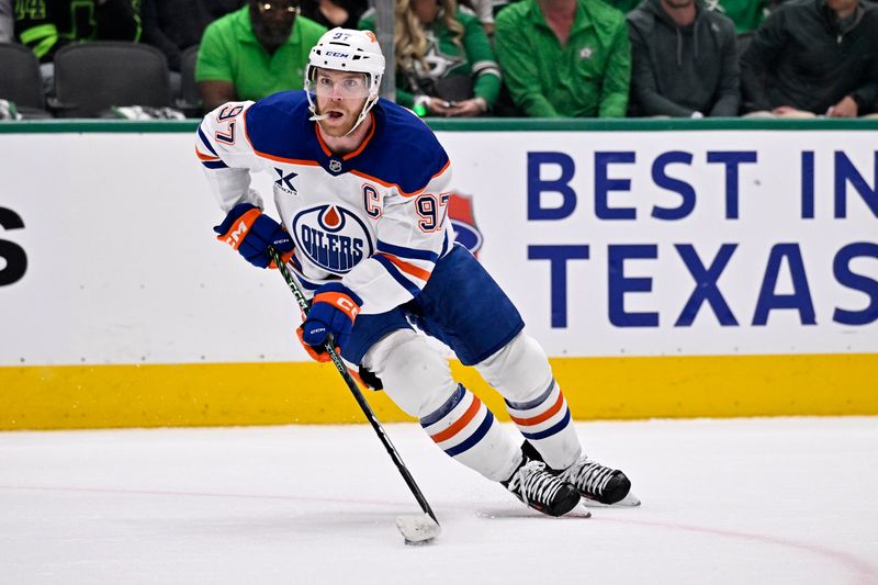 May 23, 2025; Dallas, Texas, USA; Edmonton Oilers center Connor McDavid (97) skates with the puck against the Dallas Stars in the first period for game two of the Western Conference Final of the 2025 Stanley Cup Playoffs at American Airlines Center. Mandatory Credit: Jerome Miron-Imagn Images
