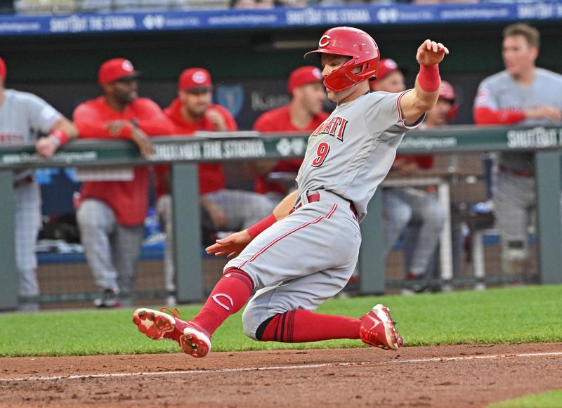 Jun 14, 2023; Kansas City, Missouri, USA;  Cincinnati Reds second baseman Matt McLain (9) slides home to score a run in the fourth inning against the Kansas City Royals at Kauffman Stadium. Mandatory Credit: Peter Aiken-USA TODAY Sports