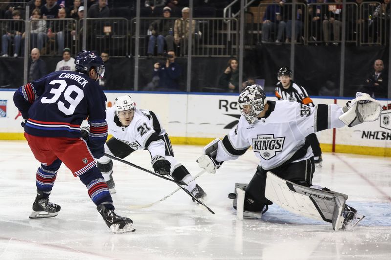 Dec 14, 2024; New York, New York, USA;  Los Angeles Kings goaltender Darcy Kuemper (35) makes a save on a shot on goal attempt by New York Rangers center Sam Carrick (39) in the second period at Madison Square Garden. Mandatory Credit: Wendell Cruz-Imagn Images