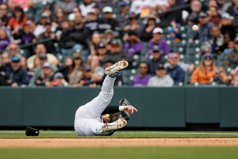 Apr 10, 2024; Denver, Colorado, USA; Colorado Rockies second baseman Brendan Rodgers (7) makes a throw to first from his back for an out in the sixth inning against the Arizona Diamondbacks at Coors Field. Mandatory Credit: Isaiah J. Downing-USA TODAY Sports