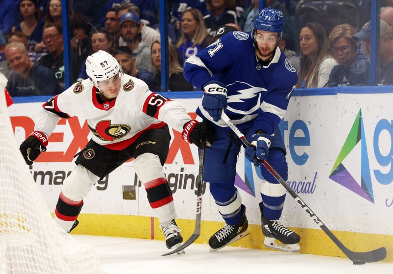 Apr 11, 2024; Tampa, Florida, USA; Tampa Bay Lightning center Anthony Cirelli (71) skates with the puck as Ottawa Senators center Shane Pinto (57) defends during the first period at Amalie Arena. Mandatory Credit: Kim Klement Neitzel-USA TODAY Sports