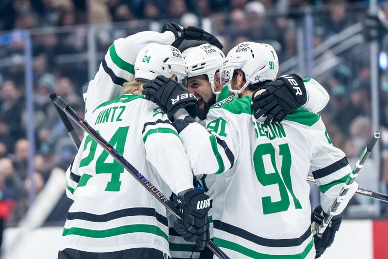 Nov 26, 2025; Seattle, Washington, USA; Dallas Stars forward Roope Hintz (24), forward Jamie Benn (14), center, an dforward Tyler Seguin (91) celebrate a goal during the first period against the Seattle Kraken at Climate Pledge Arena. Mandatory Credit: Stephen Brashear-Imagn Images