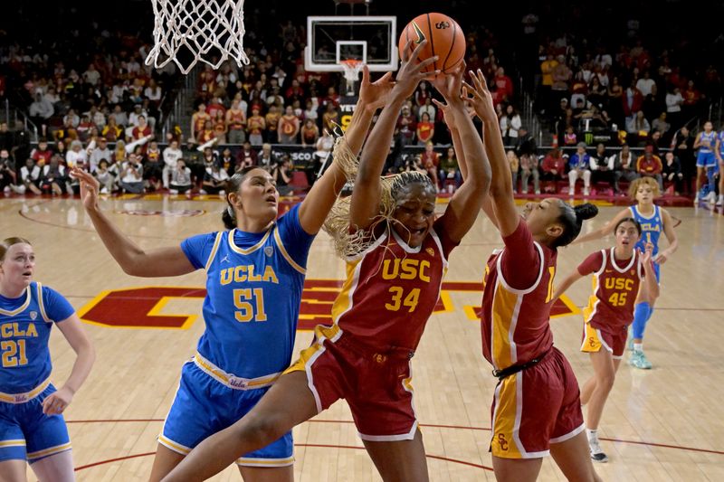 Jan 14, 2024; Los Angeles, California, USA; UCLA Bruins center Lauren Betts (51), USC Trojans center Clarice Akunwafo (34) and guard JuJu Watkins (12) go for a rebound in the first half at Galen Center. Mandatory Credit: Jayne Kamin-Oncea-USA TODAY Sports