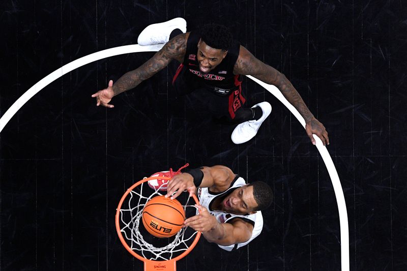 Jan 6, 2024; San Diego, California, USA; San Diego State Aztecs forward Jaedon LeDee (13) goes to the basket as UNLV Rebels forward Kalib Boone (10) reacts during the first half at Viejas Arena. Mandatory Credit: Orlando Ramirez-USA TODAY Sports