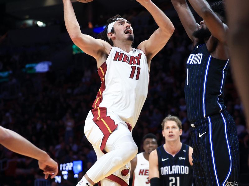 MIAMI, FLORIDA - OCTOBER 23: Jaime Jaquez Jr. #11 of the Miami Heat drives to the net against the Orlando Magic during the second half at Kaseya Center on October 23, 2024 in Miami, Florida. NOTE TO USER: User expressly acknowledges and agrees that, by downloading and or using this photograph, User is consenting to the terms and conditions of the Getty Images License Agreement. (Photo by Carmen Mandato/Getty Images)