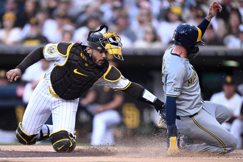 Jun 20, 2024; San Diego, California, USA; Milwaukee Brewers second baseman Brice Turang (right) scores a run ahead of the tag by San Diego Padres catcher Luis Campusano (left) during the first inning at Petco Park. Mandatory Credit: Orlando Ramirez-USA TODAY Sports