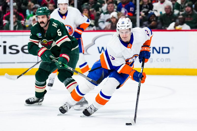Jan 15, 2024; Saint Paul, Minnesota, USA; New York Islanders center Mathew Barzal (13) protects the puck from Minnesota Wild defenseman Jake Middleton (5) during the second period at Xcel Energy Center. Mandatory Credit: Brace Hemmelgarn-USA TODAY Sports