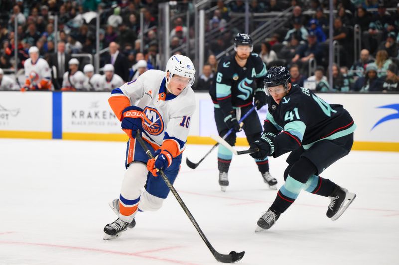 Nov 16, 2024; Seattle, Washington, USA; New York Islanders right wing Simon Holmstrom (10) plays the puck while defended by Seattle Kraken defenseman Ryker Evans (41) during the second period at Climate Pledge Arena. Mandatory Credit: Steven Bisig-Imagn Images