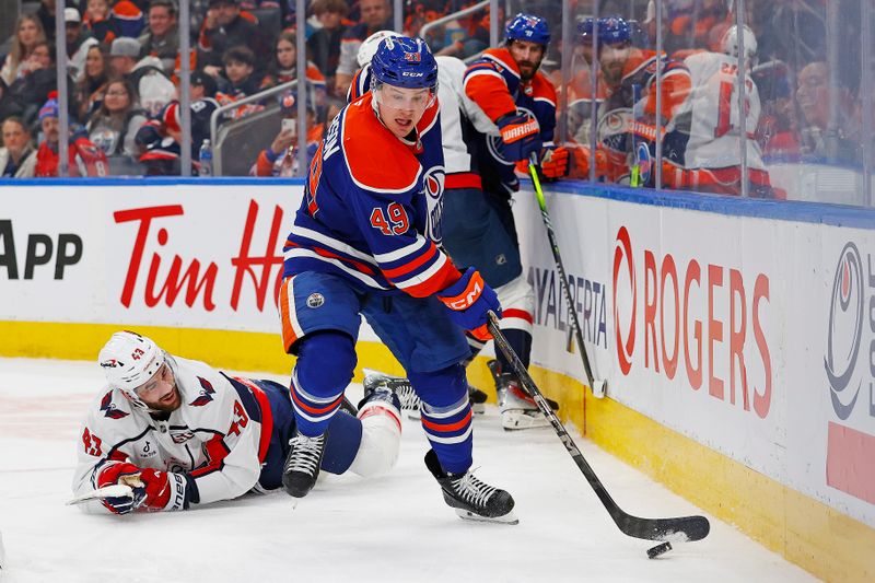 Jan 21, 2025; Edmonton, Alberta, CAN; Edmonton Oilers defensemen Ty Emberson (49) makes a pass in front of Washington Capitals forward Tom Wilson (43) during the second period at Rogers Place. Mandatory Credit: Perry Nelson-Imagn Images