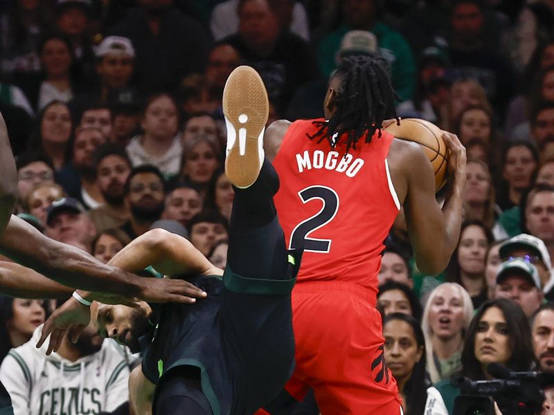 BOSTON, MA - NOVEMBER 16: Derrick White #9 of the Boston Celtics goes tumbling over Jonathan Mogbo #2 of the Toronto Raptors during the second quarter at TD Garden on November 16, 2024 in Boston, Massachusetts. NOTE TO USER: User expressly acknowledges and agrees that, by downloading and/or using this Photograph, user is consenting to the terms and conditions of the Getty Images License Agreement. (Photo By Winslow Townson/Getty Images)