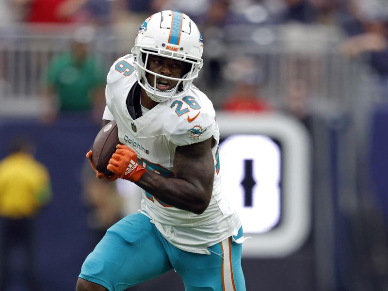 Miami Dolphins running back Salvon Ahmed (26) runs the ball during an NFL preseason football game against the Houston Texans, Saturday, Aug. 19, 2023, in Houston. (AP Photo/Tyler Kaufman)