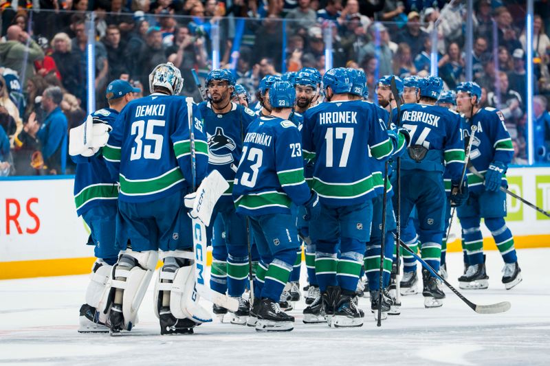Oct 3, 2025; Vancouver, British Columbia, CAN; The Vancouver Canucks celebrate their overtime victroy against the Edmonton Oilers at Rogers Arena. Mandatory Credit: Bob Frid-Imagn Images