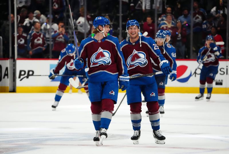 Oct 12, 2022; Denver, Colorado, USA; Colorado Avalanche defenseman Bowen Byram (4) and right wing Logan O'Connor (25) celebrate defeating the Chicago Blackhawks at Ball Arena. Mandatory Credit: Ron Chenoy-USA TODAY Sports