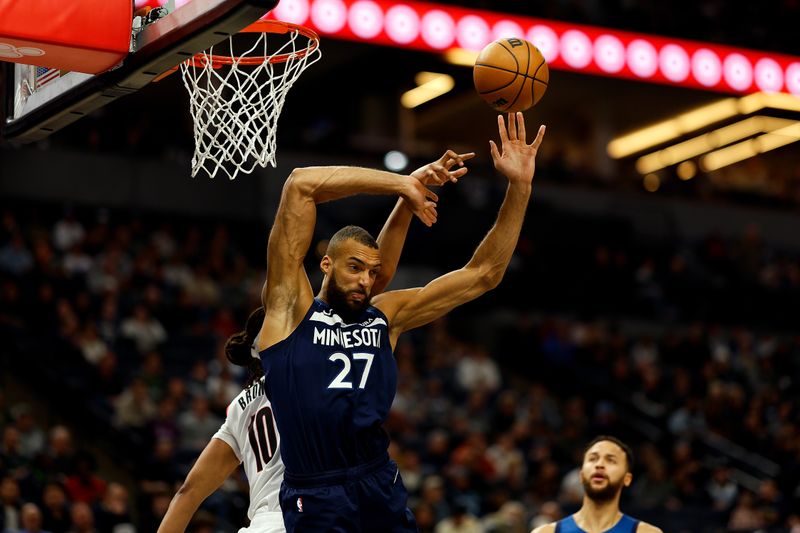 MINNEAPOLIS, MINNESOTA - MARCH 04: Rudy Gobert #27 of the Minnesota Timberwolves is fouled by Moses Brown #10 of the Portland Trail Blazers in the second quarter at Target Center on March 04, 2024 in Minneapolis, Minnesota. NOTE TO USER: User expressly acknowledges and agrees that, by downloading and or using this photograph, User is consenting to the terms and conditions of the Getty Images License Agreement. (Photo by David Berding/Getty Images)