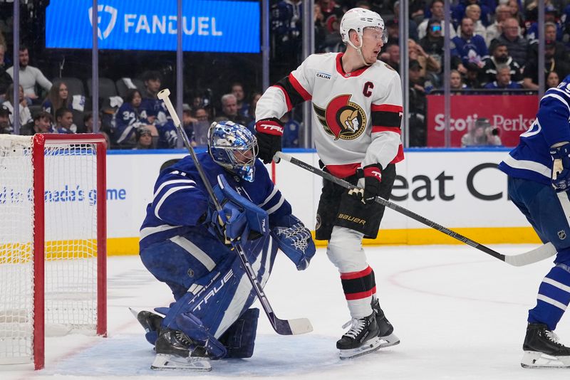 Apr 20, 2025; Toronto, Ontario, CAN; Toronto Maple Leafs goaltender Anthony Stolarz (41) looks for the puck around Ottawa Senators forward Brady Tkachuk (7) during the second period of game one of the first round of the 2025 Stanley Cup Playoffs at Scotiabank Arena. Mandatory Credit: John E. Sokolowski-Imagn Images