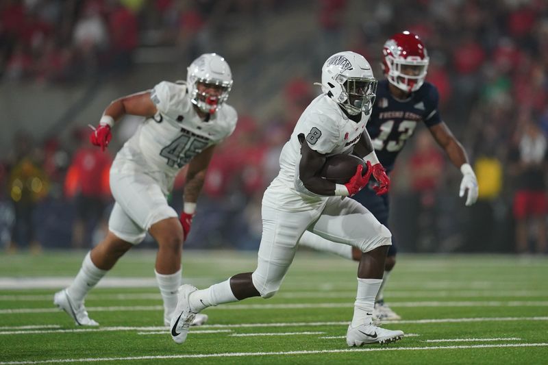 Sep 24, 2021; Fresno, California, USA; UNLV Rebels outside linebacker Kylan Wilborn (8) runs the ball against the Fresno State Bulldogs in the first quarter at Bulldog Stadium. Mandatory Credit: Cary Edmondson-USA TODAY Sports