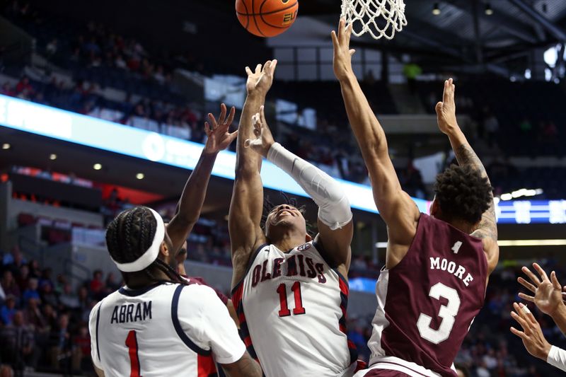 Feb 18, 2023; Oxford, Mississippi, USA; Mississippi Rebels guard Matthew Murrell (11) shoots as Mississippi State Bulldogs guard Shakeel Moore (3) defends during the second half at The Sandy and John Black Pavilion at Ole Miss. Mandatory Credit: Petre Thomas-USA TODAY Sports