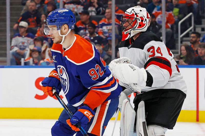 Nov 4, 2024; Edmonton, Alberta, CAN; Edmonton Oilers forward Vasily Podkolzin (92) tries to screen  New Jersey Devils goaltender Jake Allen (34) during the first period at Rogers Place. Mandatory Credit: Perry Nelson-Imagn Images