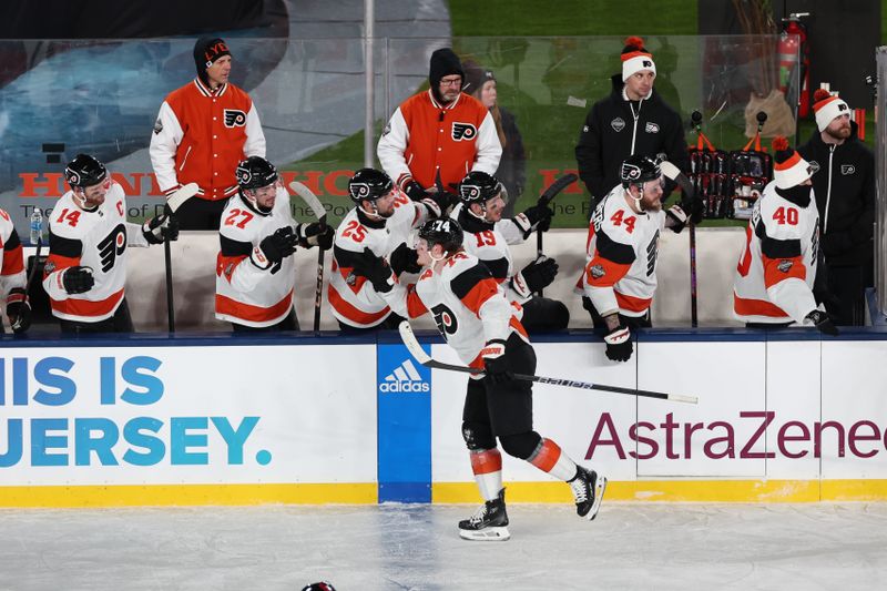 Feb 17, 2024; East Rutherford, New Jersey, USA; Philadelphia Flyers right wing Owen Tippett (74) celebrates his goal with teammates during the second period in a Stadium Series ice hockey game against the New Jersey Devils at MetLife Stadium. Mandatory Credit: Vincent Carchietta-USA TODAY Sports