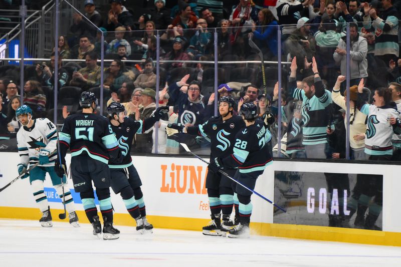 Jan 30, 2025; Seattle, Washington, USA; Seattle Kraken defenseman Brandon Montour (62) celebrates with teammates after scoring a goal against the San Jose Sharks during the second period at Climate Pledge Arena. Mandatory Credit: Steven Bisig-Imagn Images