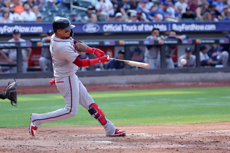 Jul 27, 2024; New York City, New York, USA; Atlanta Braves shortstop Orlando Arcia (11) hits an RBI single against the New York Mets during the fifth inning at Citi Field. Mandatory Credit: Brad Penner-USA TODAY Sports