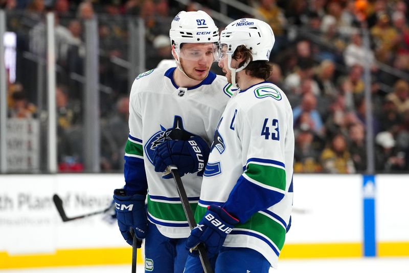 Mar 7, 2024; Las Vegas, Nevada, USA; Vancouver Canucks right wing Vasily Podkolzin (92) talks with Vancouver Canucks defenseman Quinn Hughes (43) before a face off against the Vegas Golden Knights during the first period at T-Mobile Arena. Mandatory Credit: Stephen R. Sylvanie-USA TODAY Sports