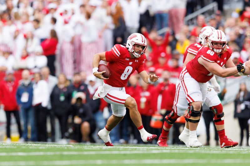 Oct 14, 2023; Madison, Wisconsin, USA;  Wisconsin Badgers quarterback Tanner Mordecai (8) rushes with the football during the first quarter against the Iowa Hawkeyes at Camp Randall Stadium. Mandatory Credit: Jeff Hanisch-USA TODAY Sports