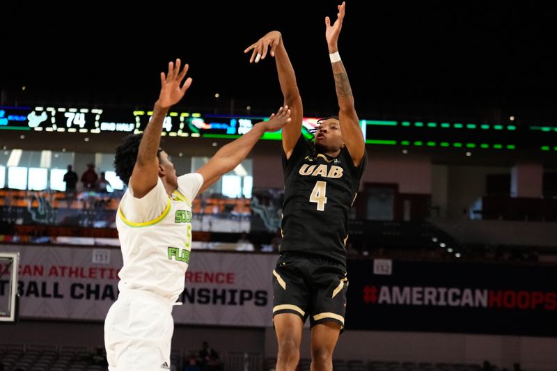 Mar 16, 2024; Fort Worth, TX, USA;  UAB Blazers guard Eric Gaines (4) scores a three point basket against South Florida Bulls guard Brandon Stroud (5) during the second half at Dickies Arena. Mandatory Credit: Chris Jones-USA TODAY Sports