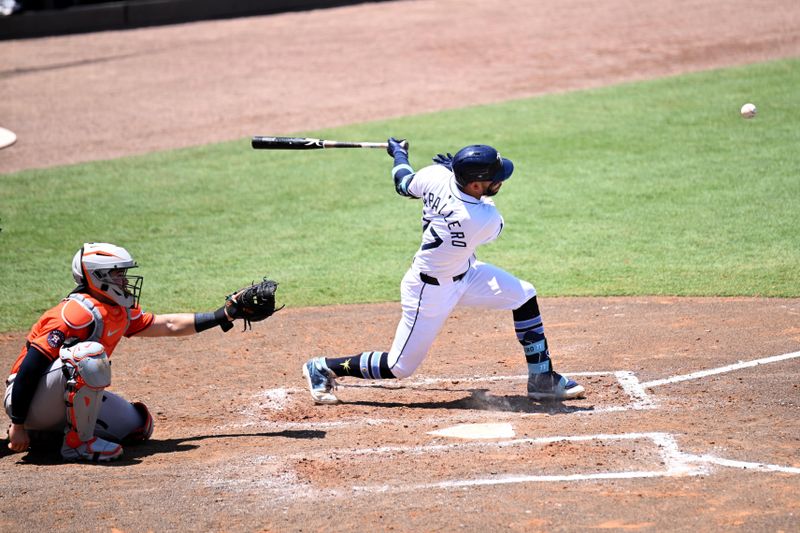 May 21, 2025; St. Petersburg, Florida, USA; Tampa Bay Rays shortstop Jose Caballero (77) hits an infield single  in the fifth  inning against the Houston Astros at George M. Steinbrenner Field. Mandatory Credit: Jonathan Dyer-Imagn Images