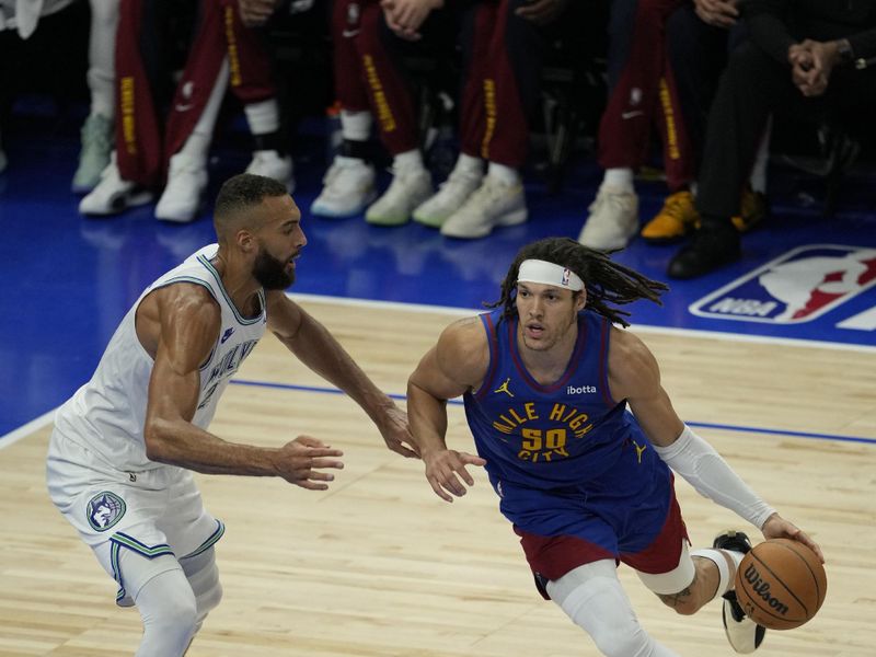 MINNEAPOLIS, MN -  MAY 16: Aaron Gordon #50 of the Denver Nuggets drives to the basket against Rudy Gobert #27 of the Minnesota Timberwolves during the game during Round 2 Game 6 of the 2024 NBA Playoffs on May 16, 2024 at Target Center in Minneapolis, Minnesota. NOTE TO USER: User expressly acknowledges and agrees that, by downloading and or using this Photograph, user is consenting to the terms and conditions of the Getty Images License Agreement. Mandatory Copyright Notice: Copyright 2024 NBAE (Photo by Jordan Johnson/NBAE via Getty Images)