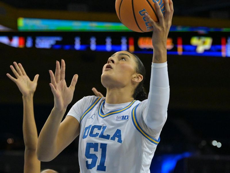 Dec 16, 2025; Los Angeles, California, USA;  UCLA Bruins center Lauren Betts (51) drives past Cal Poly Mustangs forward Charish Thompson (32) for a basket during the first half at Pauley Pavilion presented by Wescom Financial. Mandatory Credit: Jayne Kamin-Oncea-Imagn Images